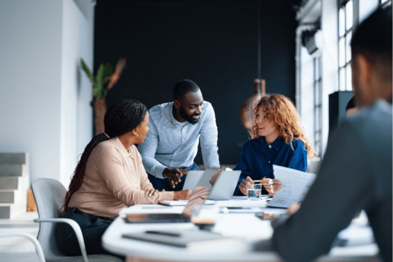 Group of professionals at a table reviewing documents.