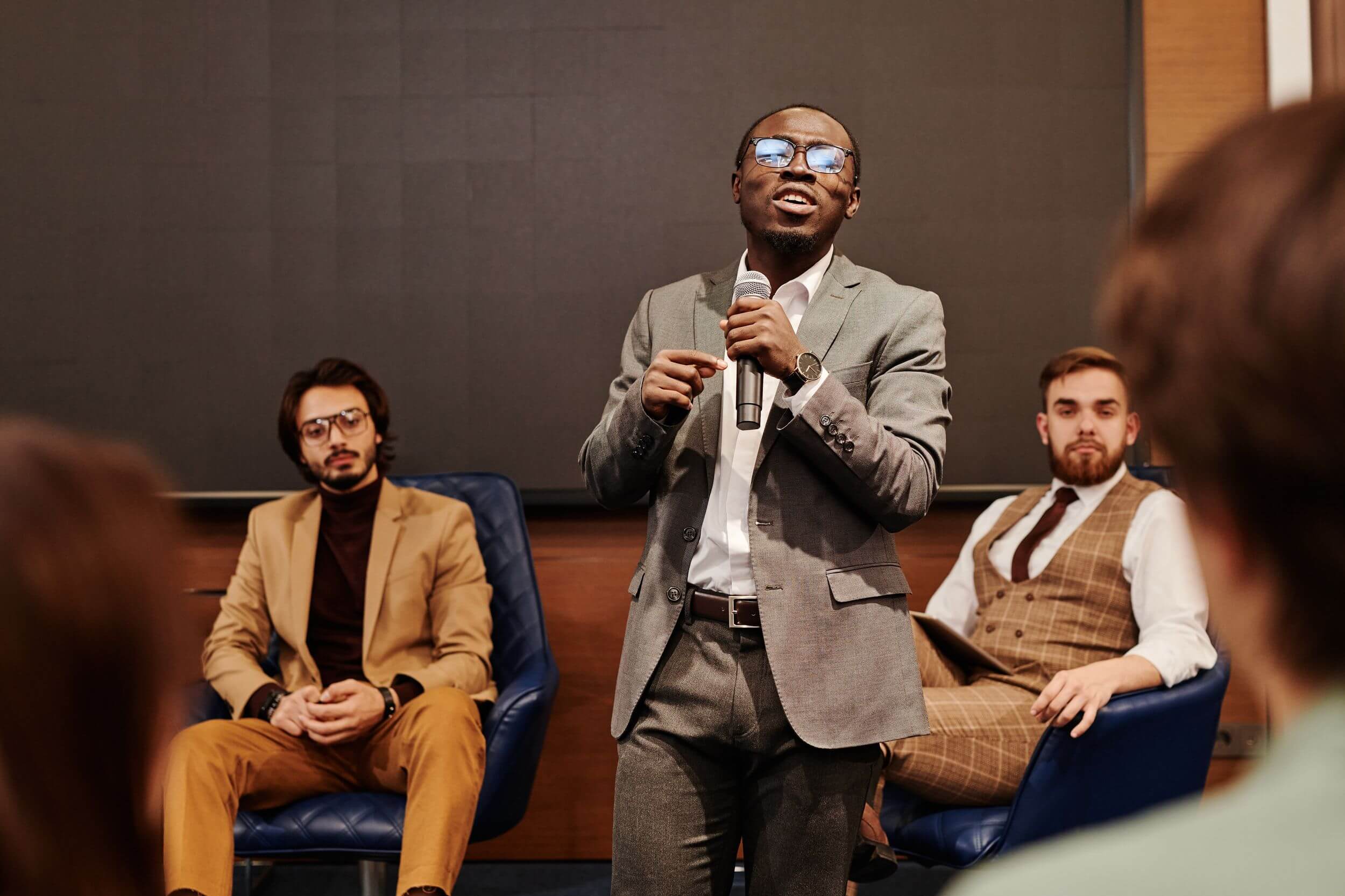 a man speaking to a group of people