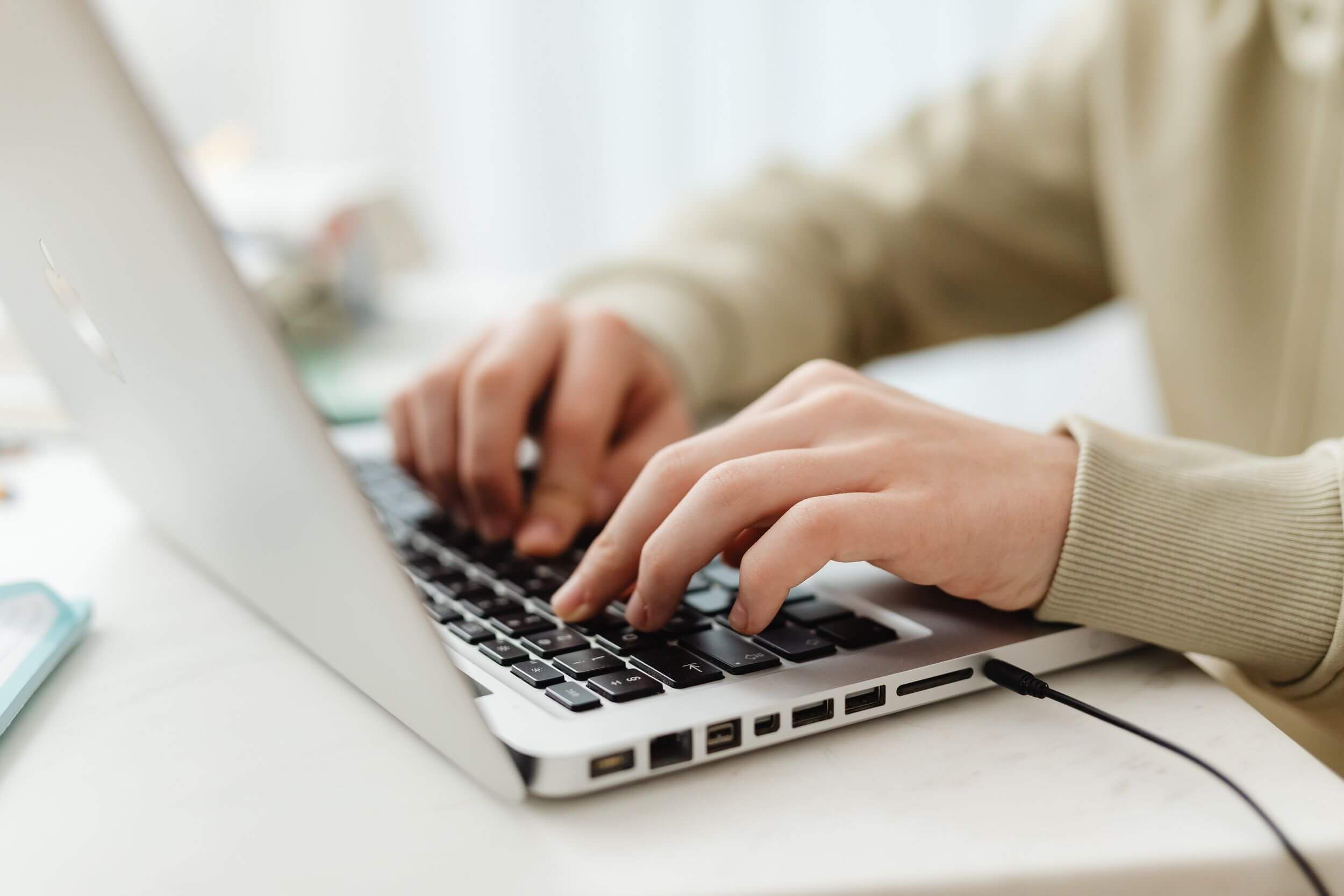 a person typing on a laptop