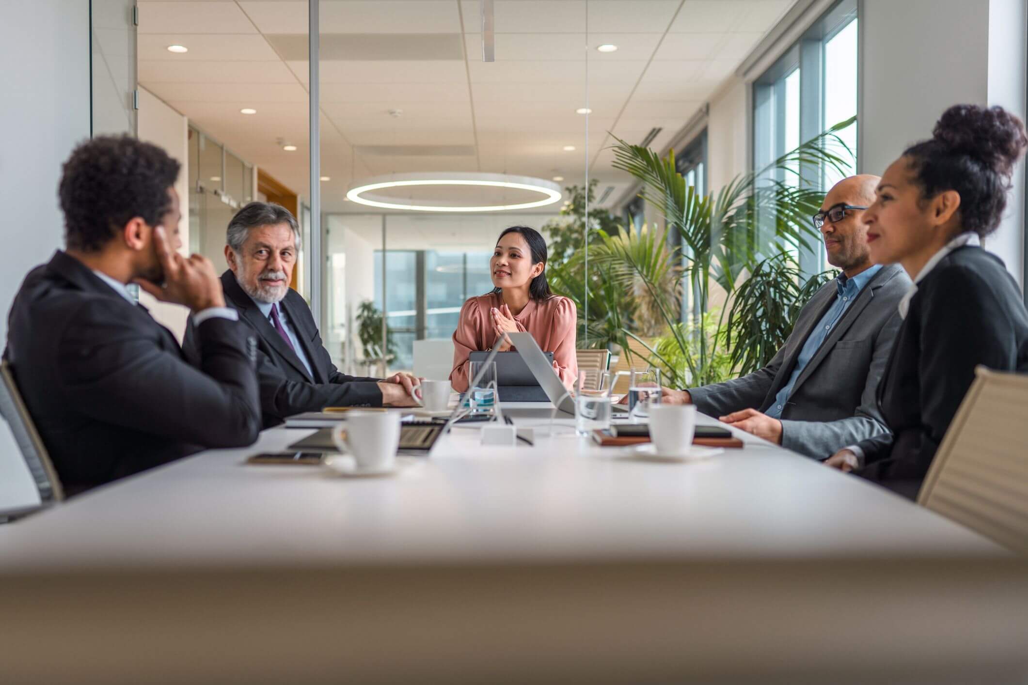 Businesswoman conducts meeting at a table