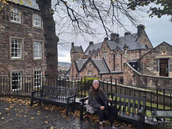 Tania sitting on a bench in Edinburgh