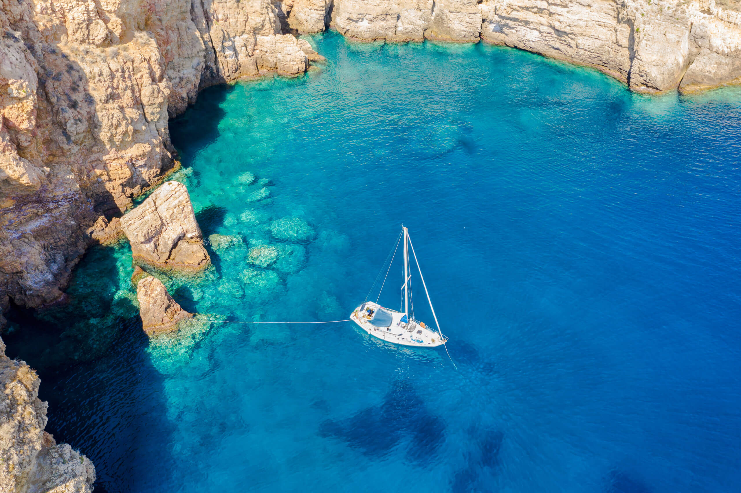 Overhead shot of a Click&Boat boat rental out on crystal blue waters