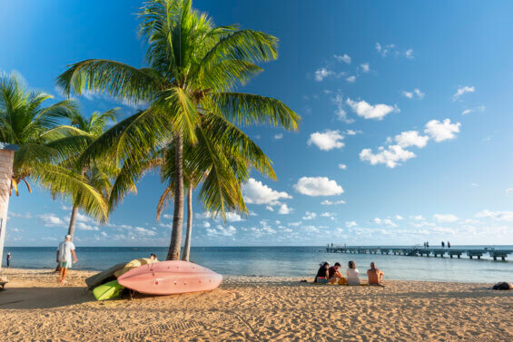 People gather on the sand to watch the sunset in tropical Key West Florida USA