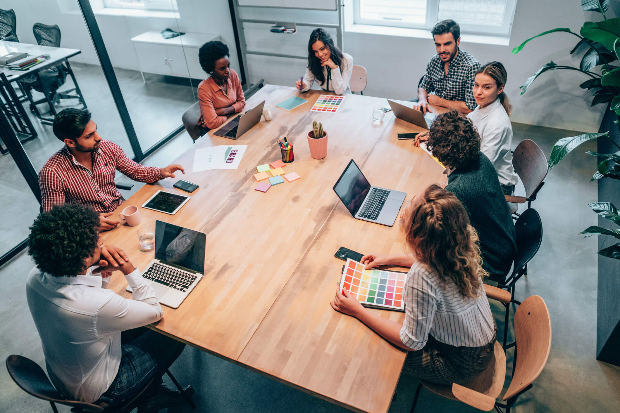 Team discussing strategic planning branding in an office with a large wooden desk