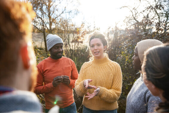 Local woman talking to a group of people in her community