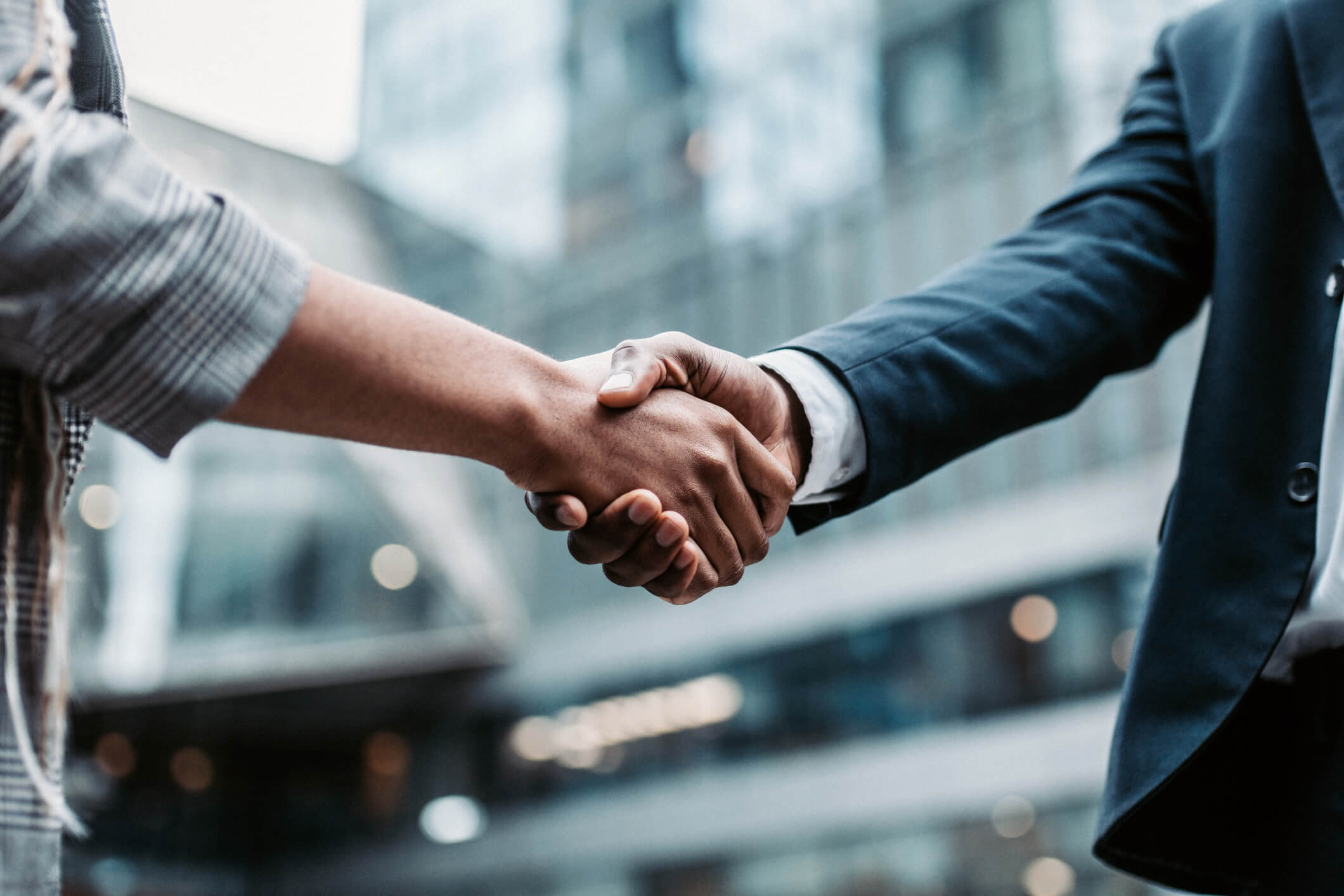 Two people with no conflict of interest shaking hands in partnership.