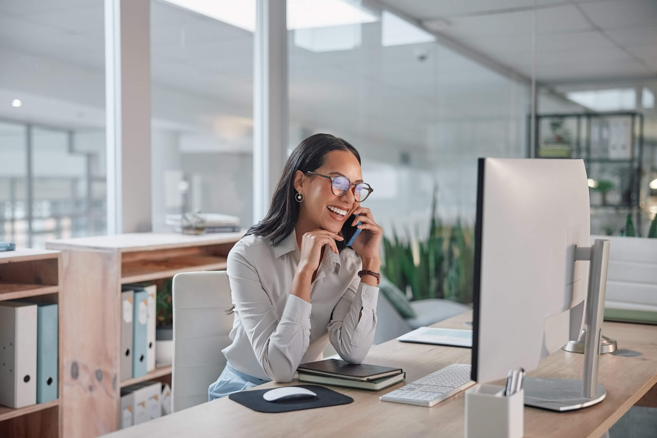 Woman sitting at a computer and evaluating if she her economic development website is outdated