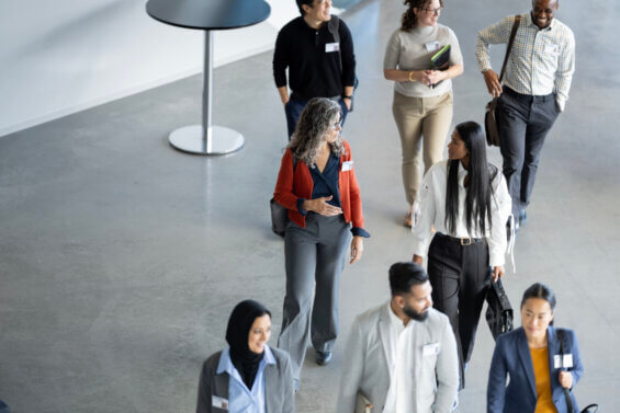 Diverse group of people walking into an in-person travel trade show