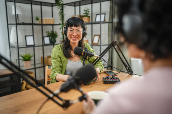 woman in the podcast studio talk and record, focus on a japanese woman talk into a mic